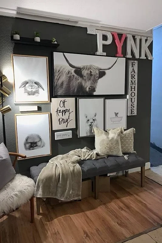 Charcoal wall with a framed animal gallery and a tufted bench